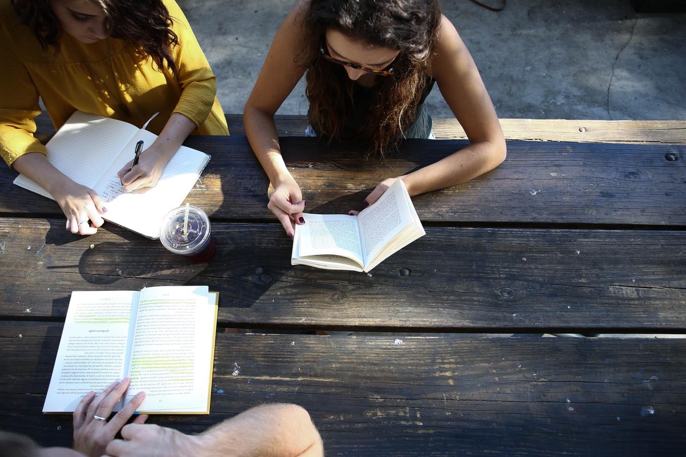 people studying outside at a table